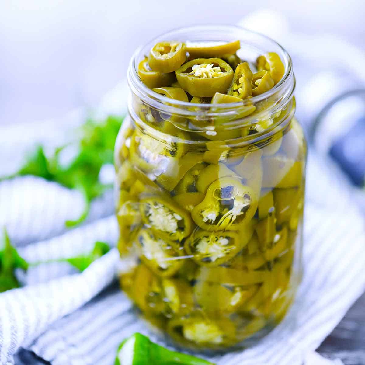 Learn how to make restaurant-quality spicy and fiery pickled jalapeño peppers at home with this simple, crunchy recipe.